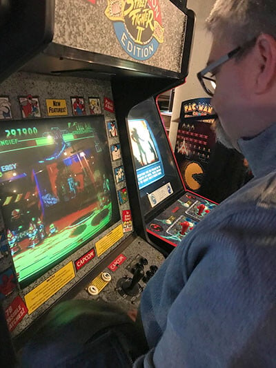 Todd Hannigan playing an arcade game